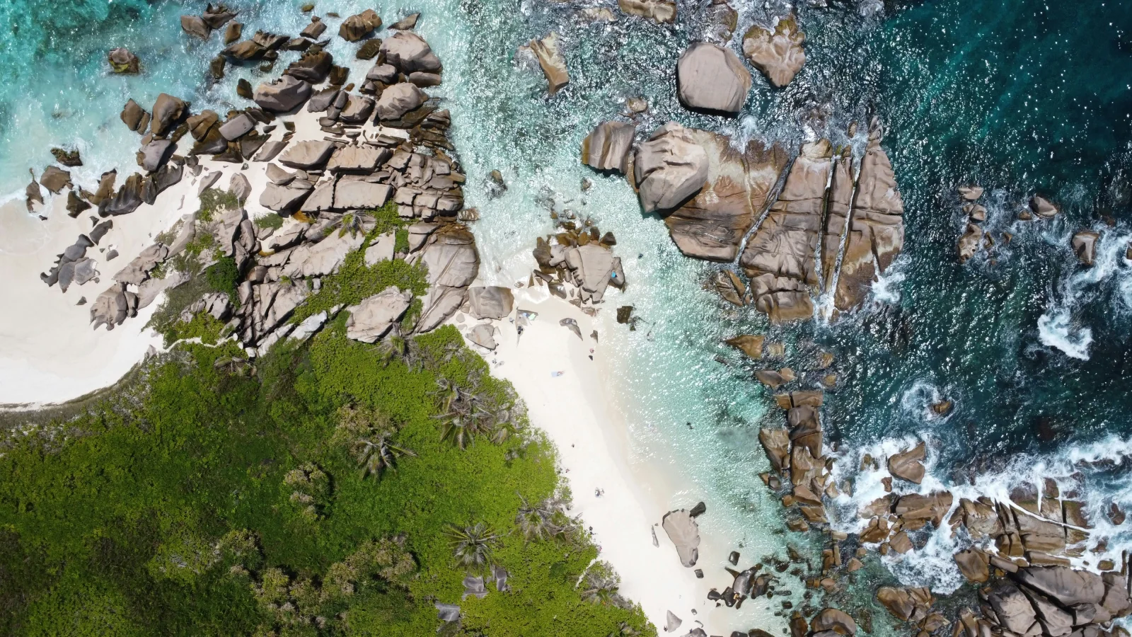 Turquoise water, white sand and granite rocks along the Seychelles coast.